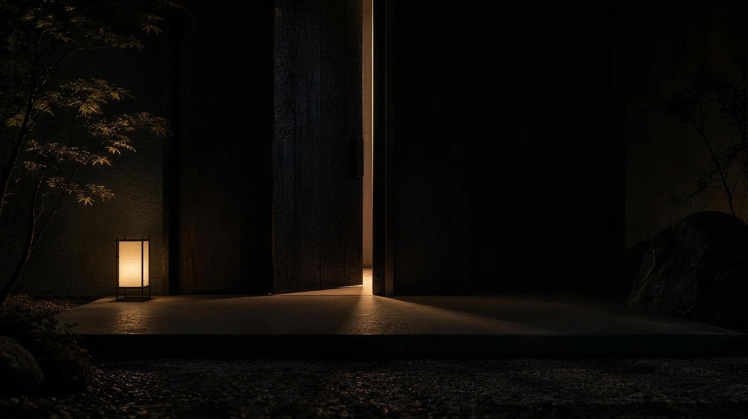 A tall charred-timber door, slightly ajar, a thin line of warm light on a stone step.