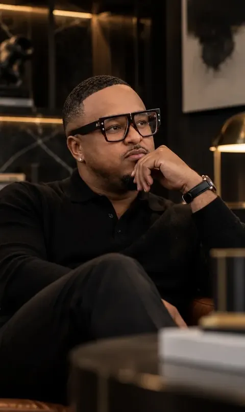 Brennon Jackson, founder of EYEGASMIC, by a window.